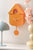 Wanduhr im orangefarbenen Vogelhäuschen-Design mit Zeigern und Sichtöffnung