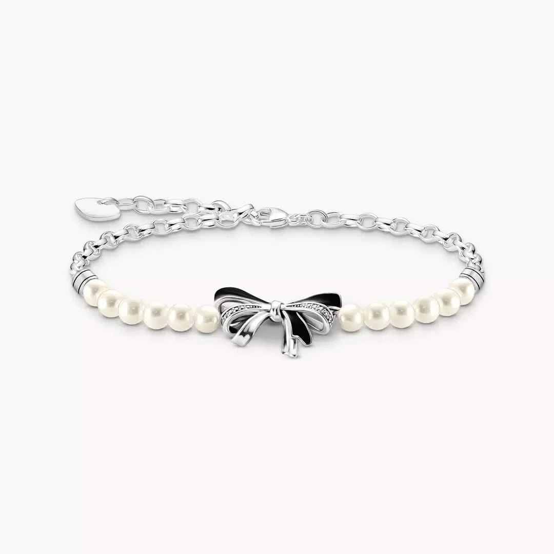 alt
A silver ring with a black stone in the center, surrounded by smaller white stones.