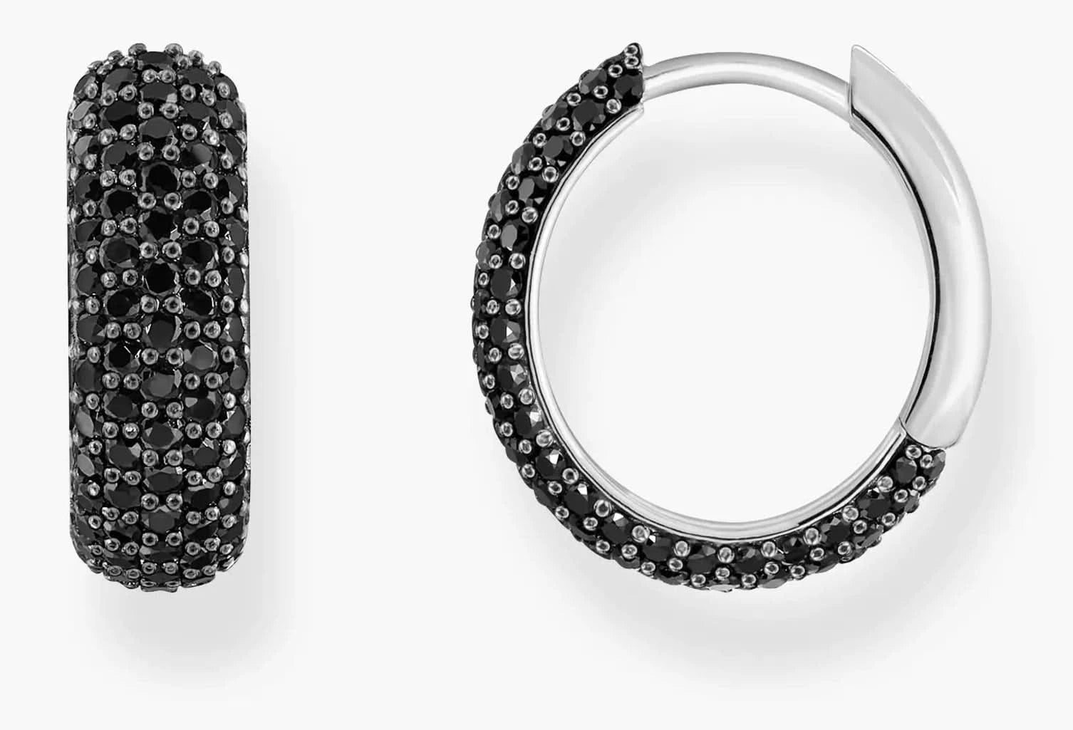 alt
Sterling silver ring with a large, faceted blue-grey synthetic spinel and smaller white zirconia stones.
