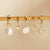 ANIA HAIE E043-04G Creole earrings with oval pearl pendant and zirconia stone