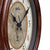 Wall clock dial detail with AMS, beige background, black hands and index ring