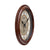 Wall clock in an oval antique brown casing with a glass front and visible side view