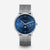 Naos Midnight Blue Silver Moon Phase watch with silver Milanese strap, front view, gray background