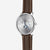 alt
Naos Moon Phase watch in silver with a dark brown bridle leather strap, shown at a 45-degree angle against a grey background.
