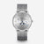 Naos Moon Phase watch with silver Milanese strap, silver dial, front view, gray background