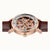 Ingersoll Armbanduhr mit roségoldener Lünette, sichtbarem Werk und braunem Lederband