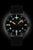 Men's watch with black dial, orange luminous markers, and leather strap