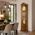 Walnut grandfather clock in living room, large glass display with dial and pendulum rods