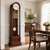 Wooden grandfather clock with glass insert, round dial, and golden chime rods