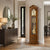 Walnut grandfather clock in hallway, glass case with dial and pendulum