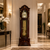 Wooden grandfather clock with moon phase and dial, glass front, and pendulum