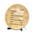 Round clock face of a table clock with word display, antique brass look, black lettering, and stand