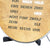 Close-up of a round word clock dial in antique brass look with black text