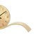 Close-up of a table clock: rim of the round dial and curved wooden base with brass look