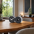 Table and wall clock with metal casing, two round clocks on wooden table, 12 visible
