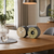 Wooden table clock with wood dial and black casing on a wooden table
