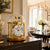 Gold table clock with round glass dome and analog dial on wooden base