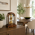 Wooden table clock on sideboard with glass arch and gold-colored dial