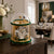 Mechanical table clock with glass dome, gold trim, and green base, Roman numerals