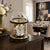 Mechanical table clock with glass dome, gold-colored frame, and Roman numeral dial