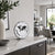Metal table clock with world time display on white dial, black hands