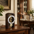 Table clock in dark wood case with visible brass movement and pendulum regulator