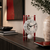Skeleton table clock with round white dial, black hands, and red bars