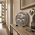 Round LED word clock on the wall with metallic dial and word display