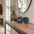 Table and wall clock with metal casing, two round clocks on sideboard, black dial