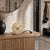 AMS table clock on wooden dresser with beige dial and curved base