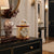 Table clock with transparent glass top, round dial, and gold-colored frame
