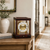 Mahogany table clock with glass front and gold columns, round dial