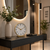 Table clock with white dial and gold hands, brass frame on console