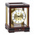 Mahogany table clock with glass frame, gold dial, and Roman numerals