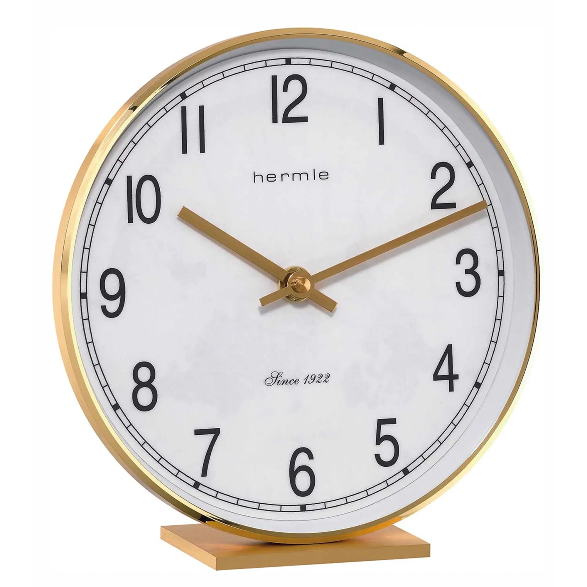 Table clock with white dial, gold hands, and brass frame on wooden base