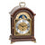 Wooden table clock with moon phase display and Roman numerals in a curved case