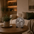 LED word clock on wooden table: round metallic-colored dial with word scale