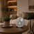 Round LED word clock table clock on wooden base with gray clock face and stand