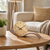 Table clock on round wooden side table, walnut wood base, dial with black hands.