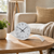 Table clock with gray dial, black numbers, and curved silver base