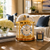 Gold table clock with glass dome, white dial, and round screw knobs