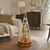 Table clock with transparent glass case, gold-colored movement, and wooden base