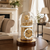 Table clock with golden interior under glass dome, base in dark brown