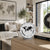 Table clock on wooden surface, white dial with world map and black hands