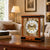 Cherry wood table clock on wooden surface, glass front with visible mounted gears