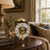 Mechanical table clock with skeleton numerals, round dial, and golden dome