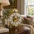 Table clock with golden glass dome and Roman numeral dial on metal feet