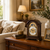 Wooden table clock with moon phase window, Roman numeral dial, and embossed brass bezel
