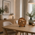 LED word clock with copper-colored round dial and text display, on table stand