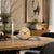 AMS table clock with beige dial and curved base on wooden table